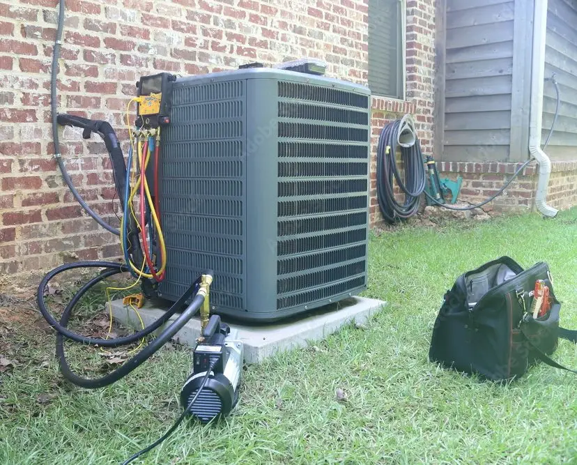 air conditioning unit undergoing maintenance