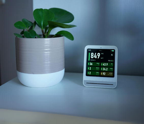 Purcell Heating and Air Ltd digital thermostat display with indoor plant – HVAC & Furnace Repair Services in Calgary