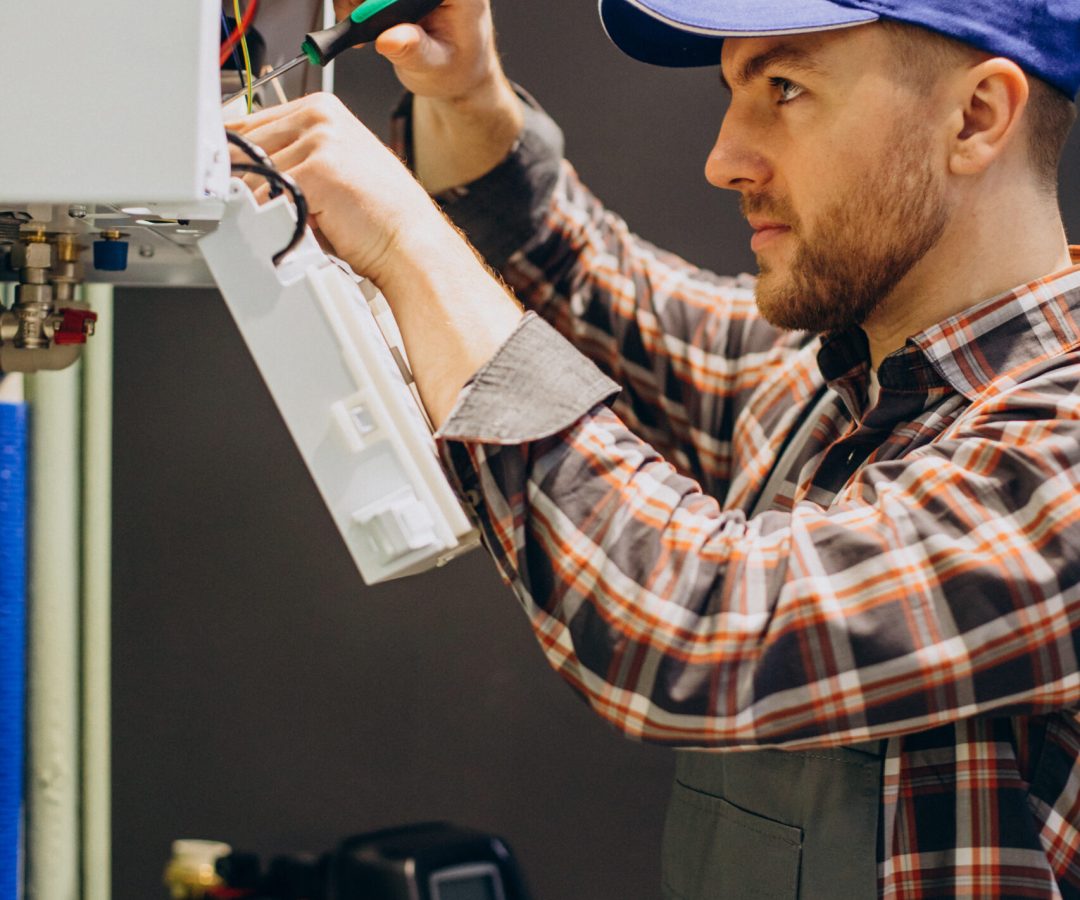 Service man adjusting house heating system Service man adjusting house heating system